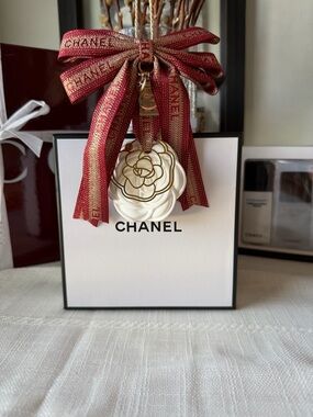 CHANEL White Camellia Charm with Red-Gold Ribbon